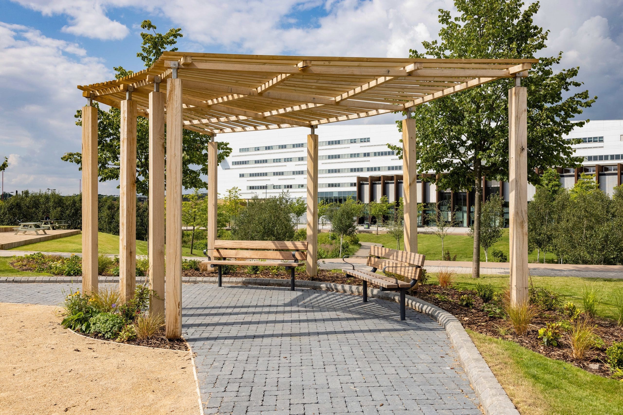 curved-wooden-pergola-over-outdoor-seating