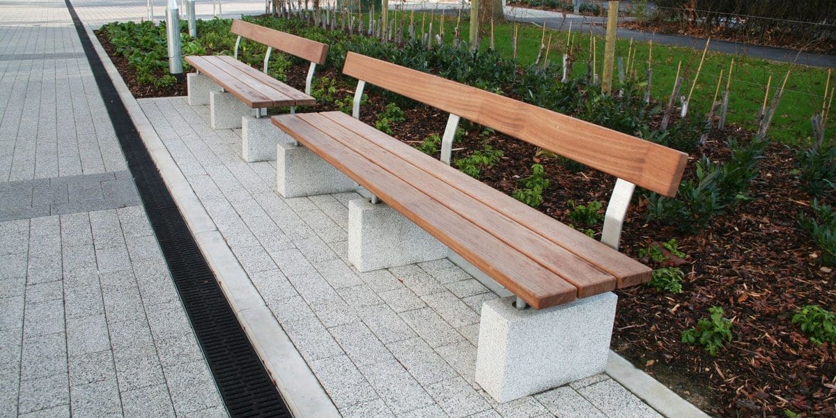 Outdoor wooden benches with concrete plinth legs