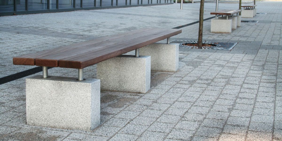 Outdoor wooden benches with concrete plinth legs