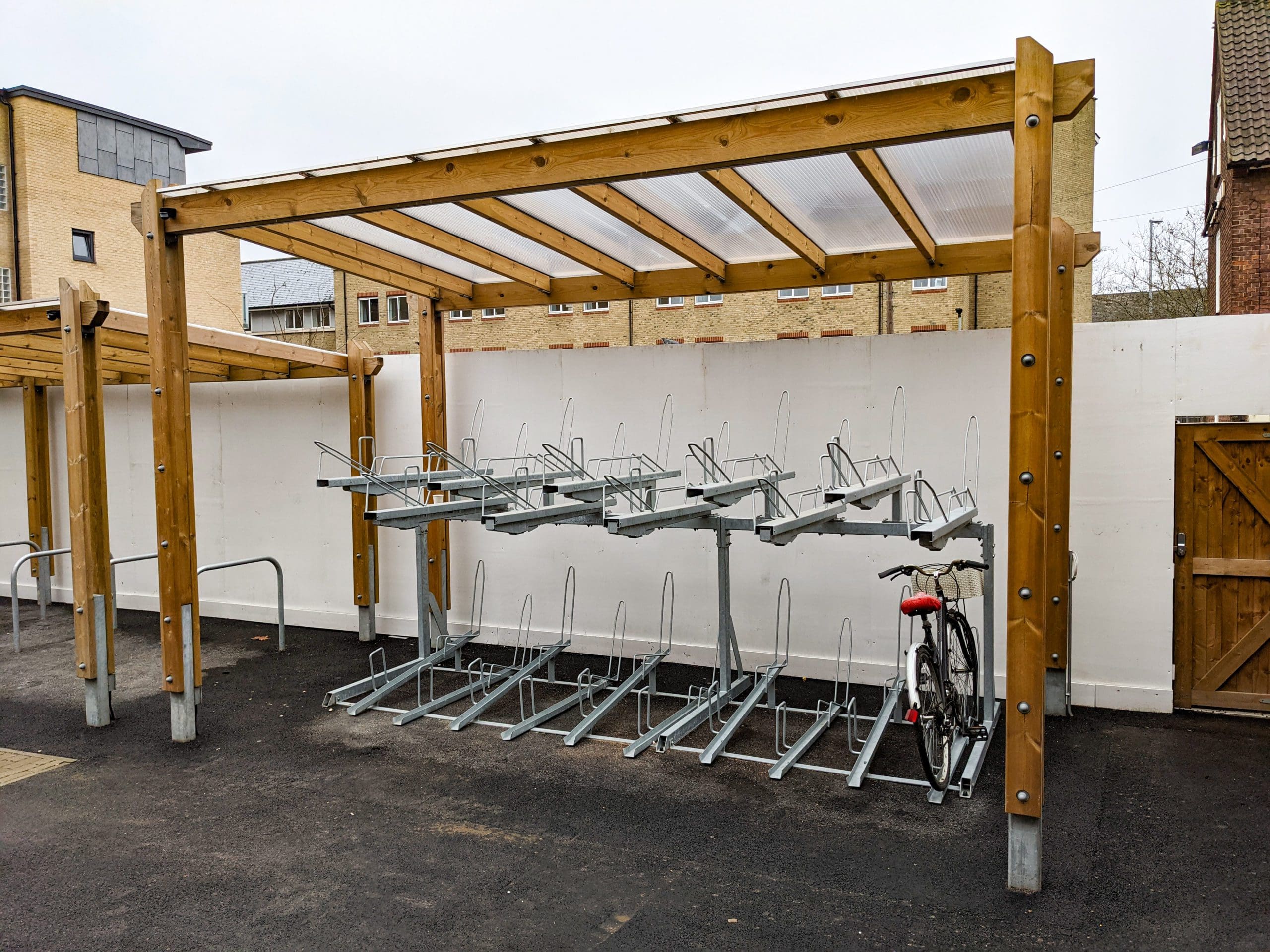 wooden pergola bike shelter with metal hoops and attachments