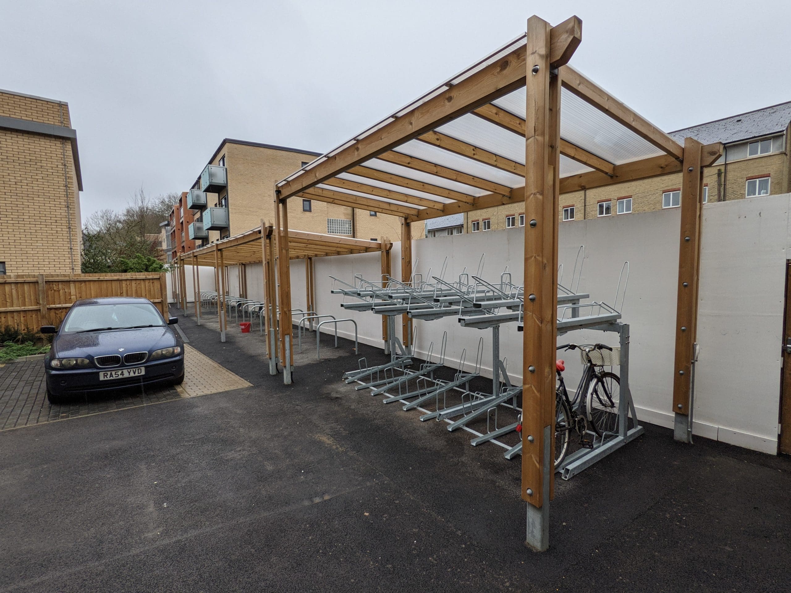 wooden pergola bike shelter with metal hoops and attachments