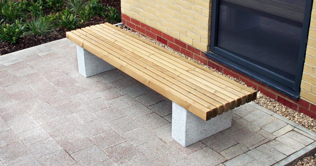 Outdoor wooden benches with concrete plinth legs
