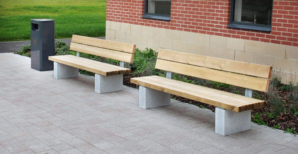 Pair of outdoor wooden benches with concrete plinth legs and wooden backs