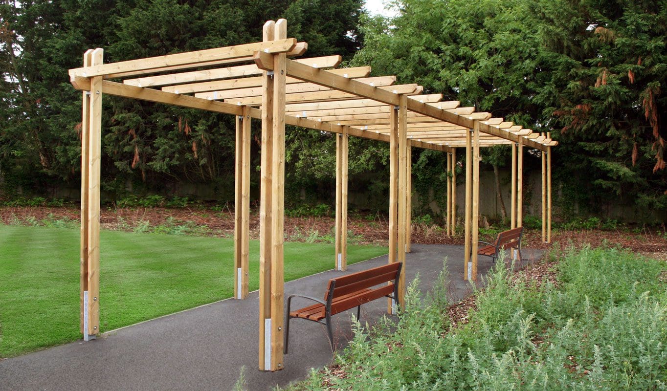 Long wooden pergola with wooden benches underneath