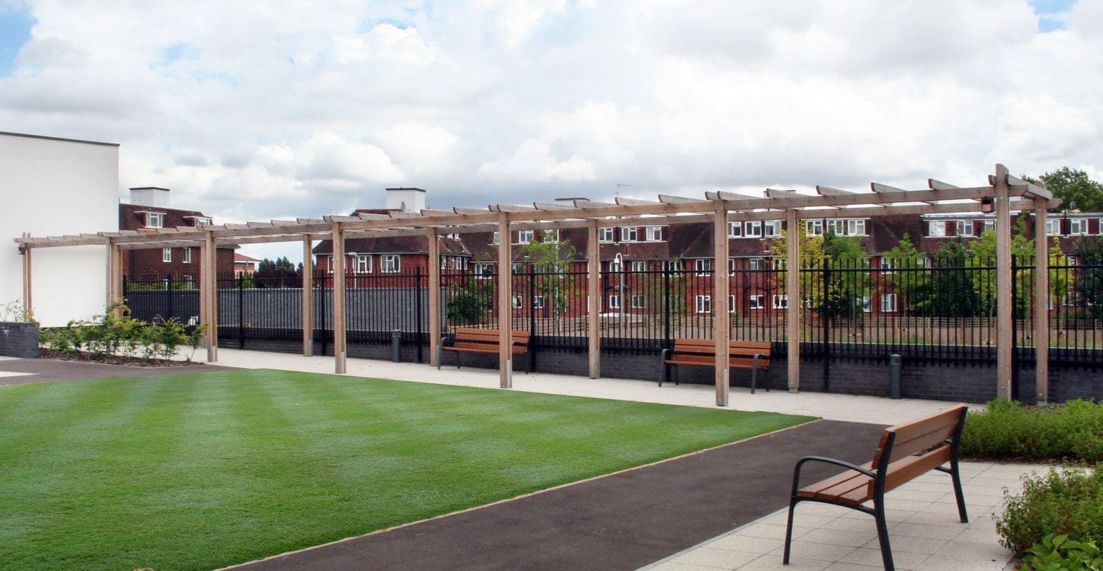 Long wooden pergola with wooden benches underneath