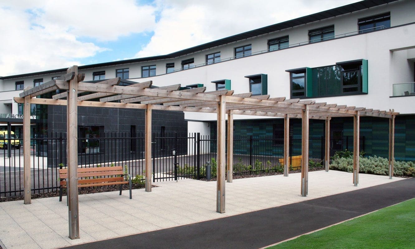 Long wooden pergola with wooden bench underneath