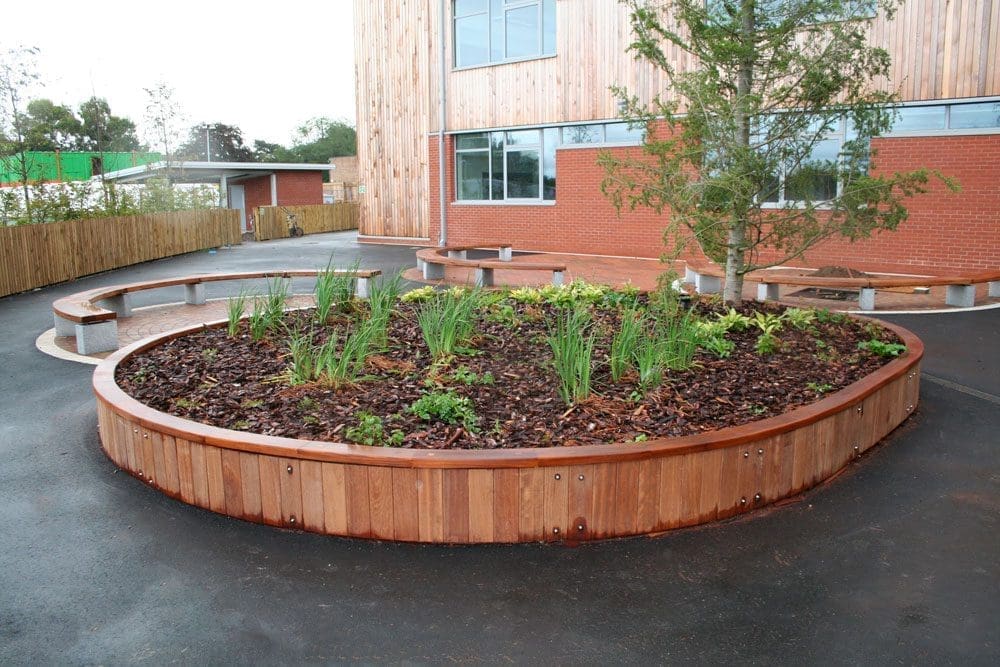 Large curved wooden raised bed planters