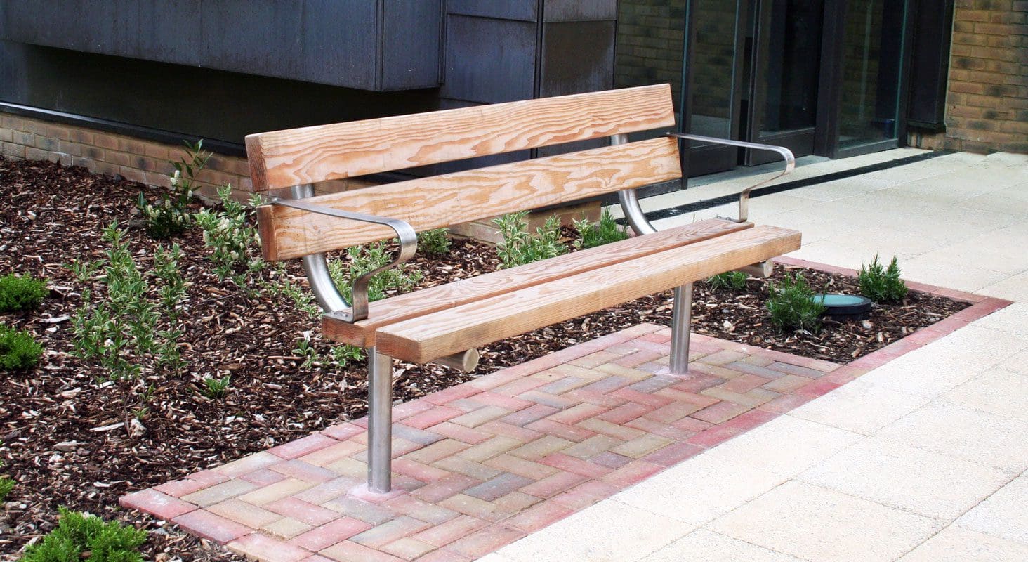 Wooden bench with metal legs and curved back