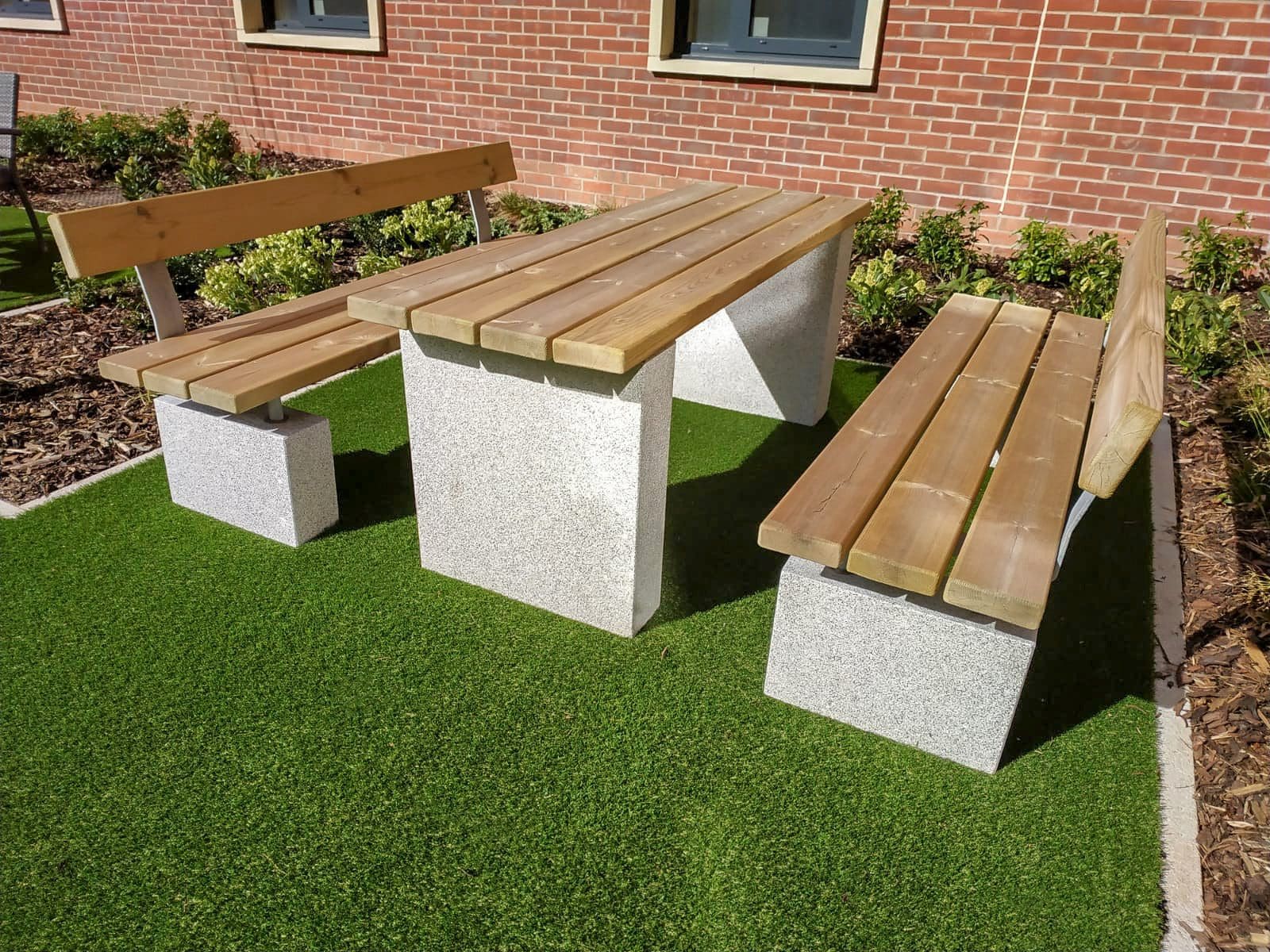 Wooden outdoor table and matching benches with concrete legs