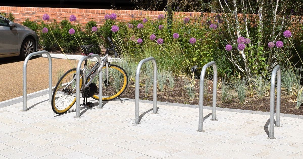 Row of silver metal bike hoops in the ground