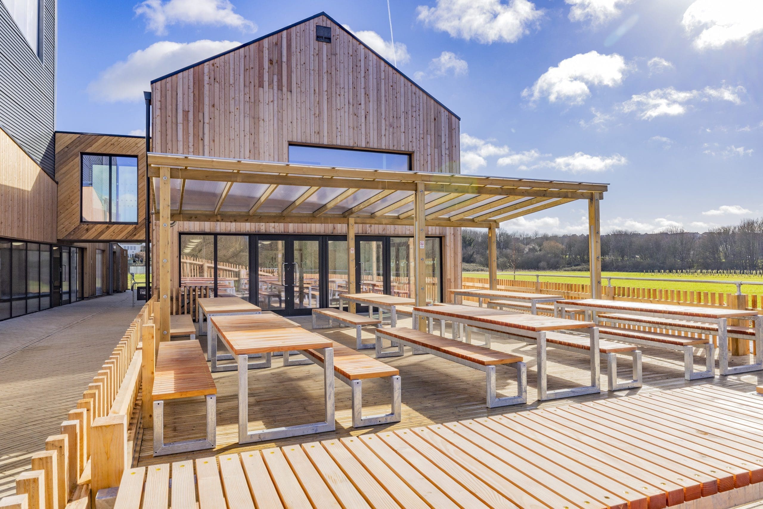 exterior-wooden-seating-area-tables-and-benches-with-wooden-pergola