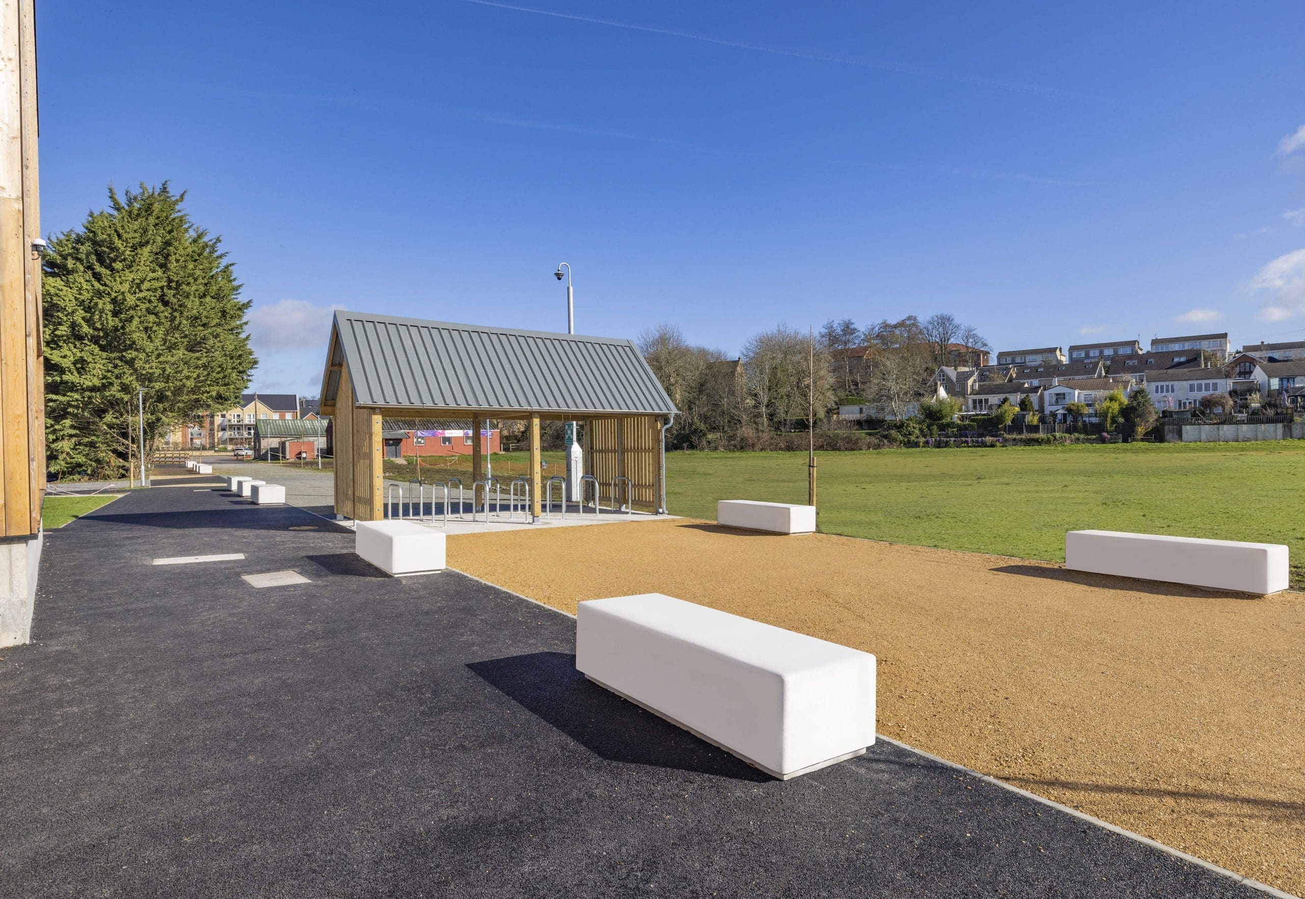 exterior-wooden-bike-storage-metal-hoops-and-concrete-block-seating-area