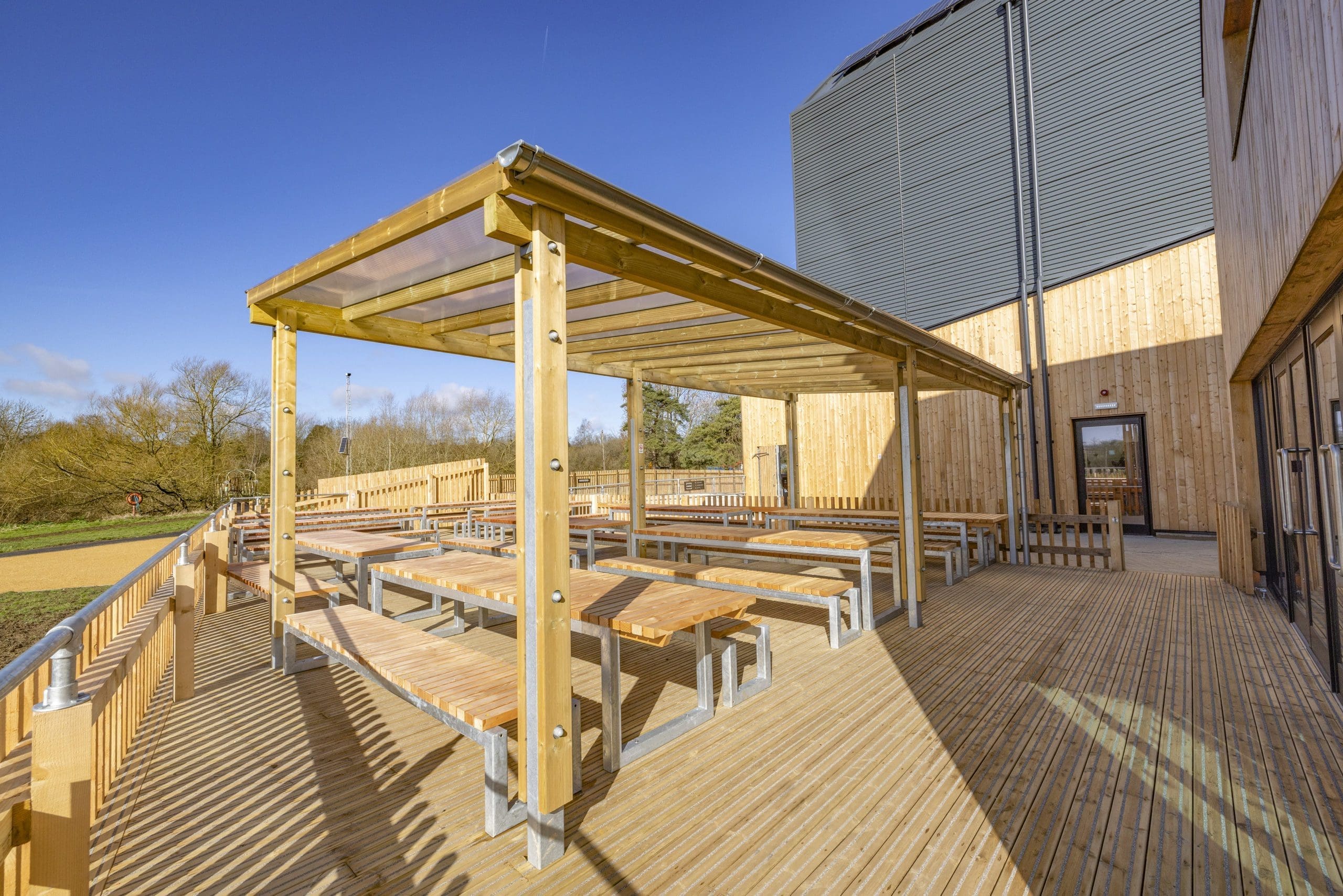 exterior-wooden-seating-area-tables-and-benches-with-wooden-pergola