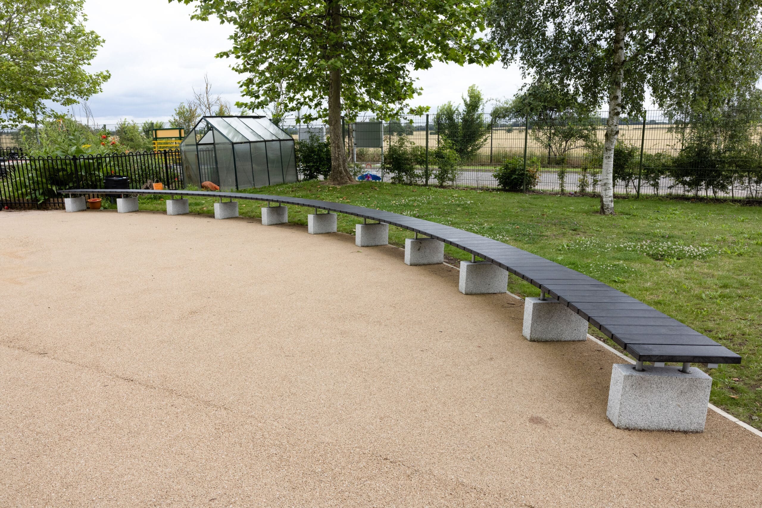 Wide semicircle curved outdoor bench black wood concrete plinths