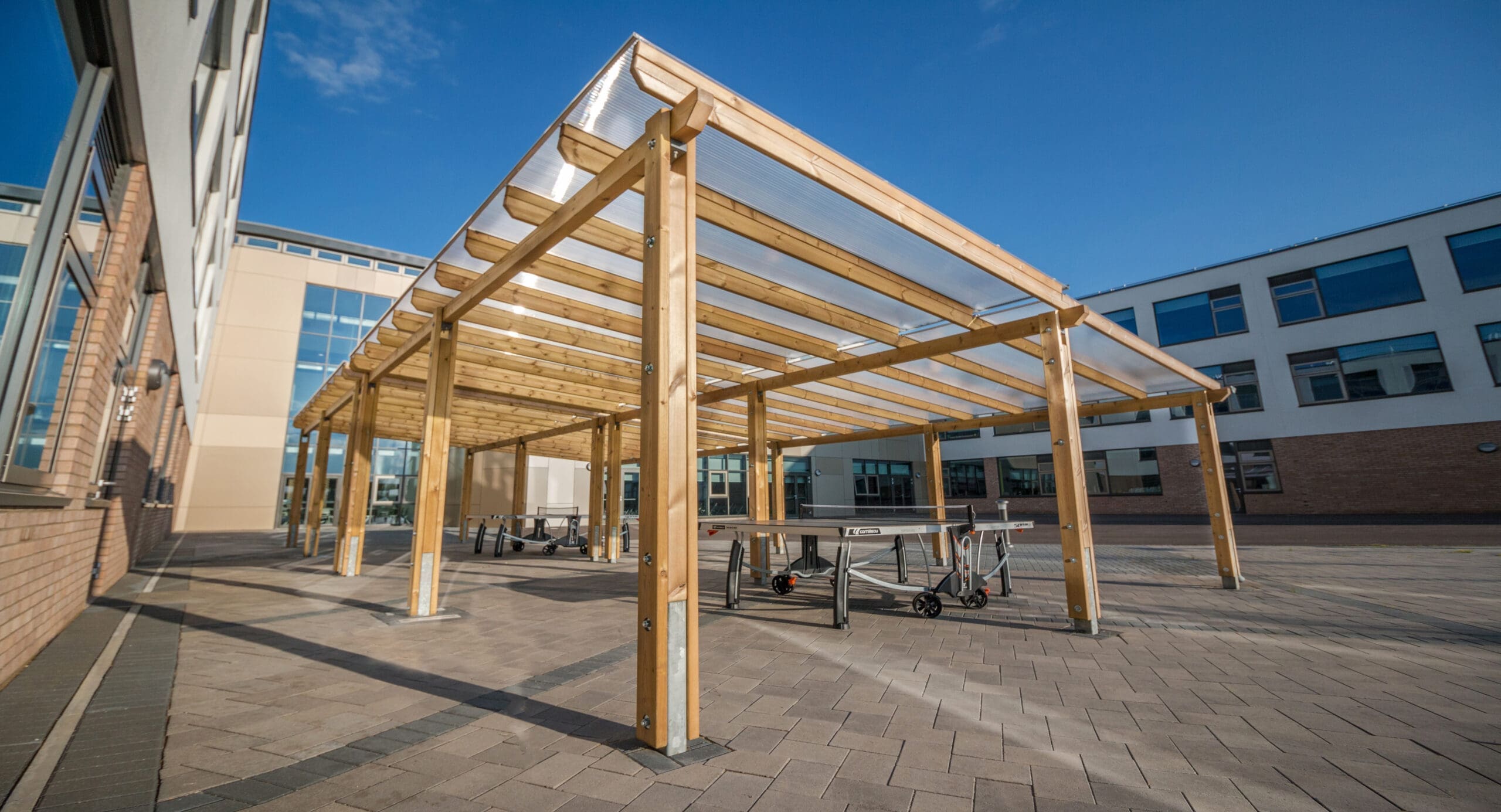 Wooden canopy building, with a clear roof.