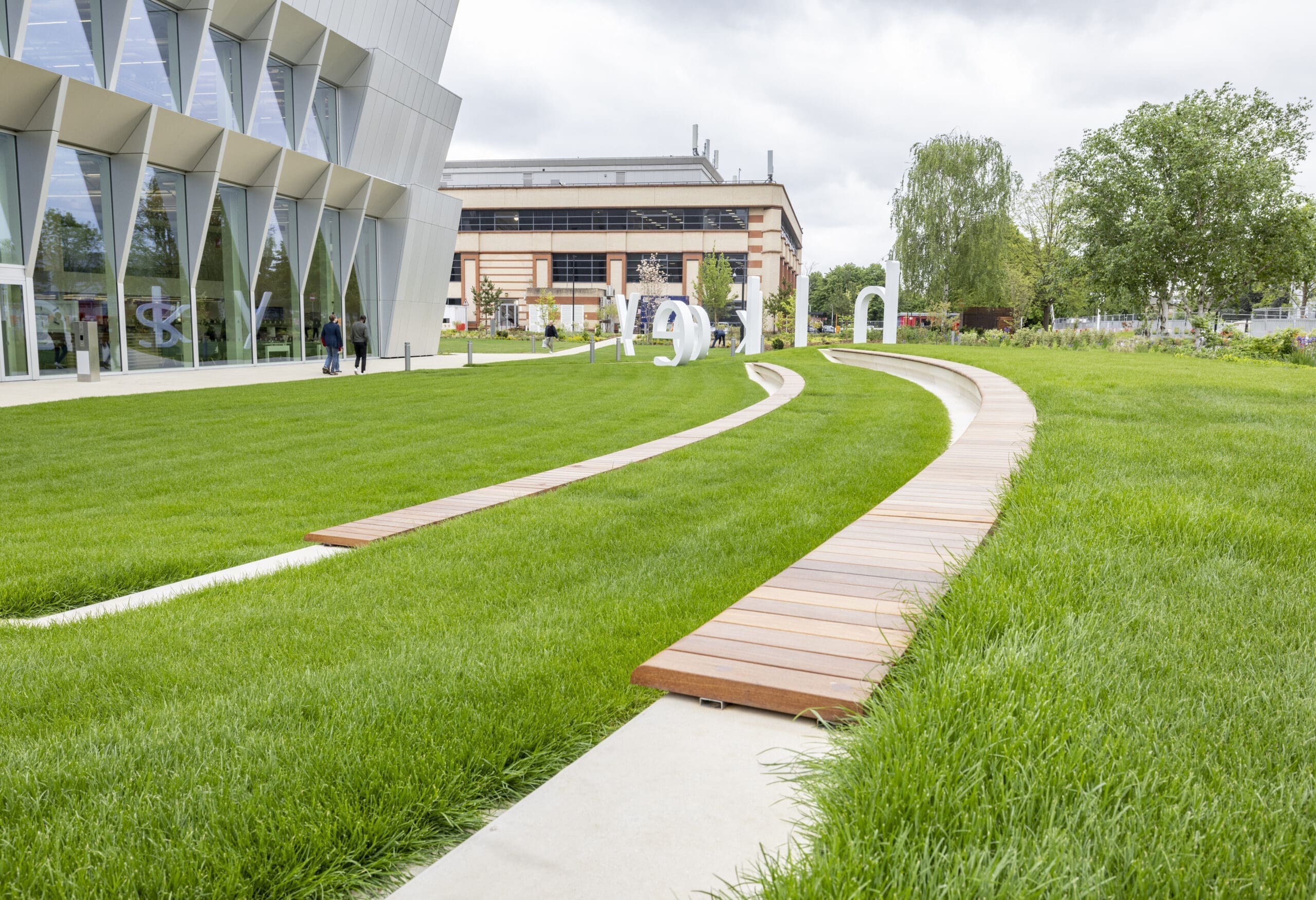 A path leading to a building, surrounded by grass.