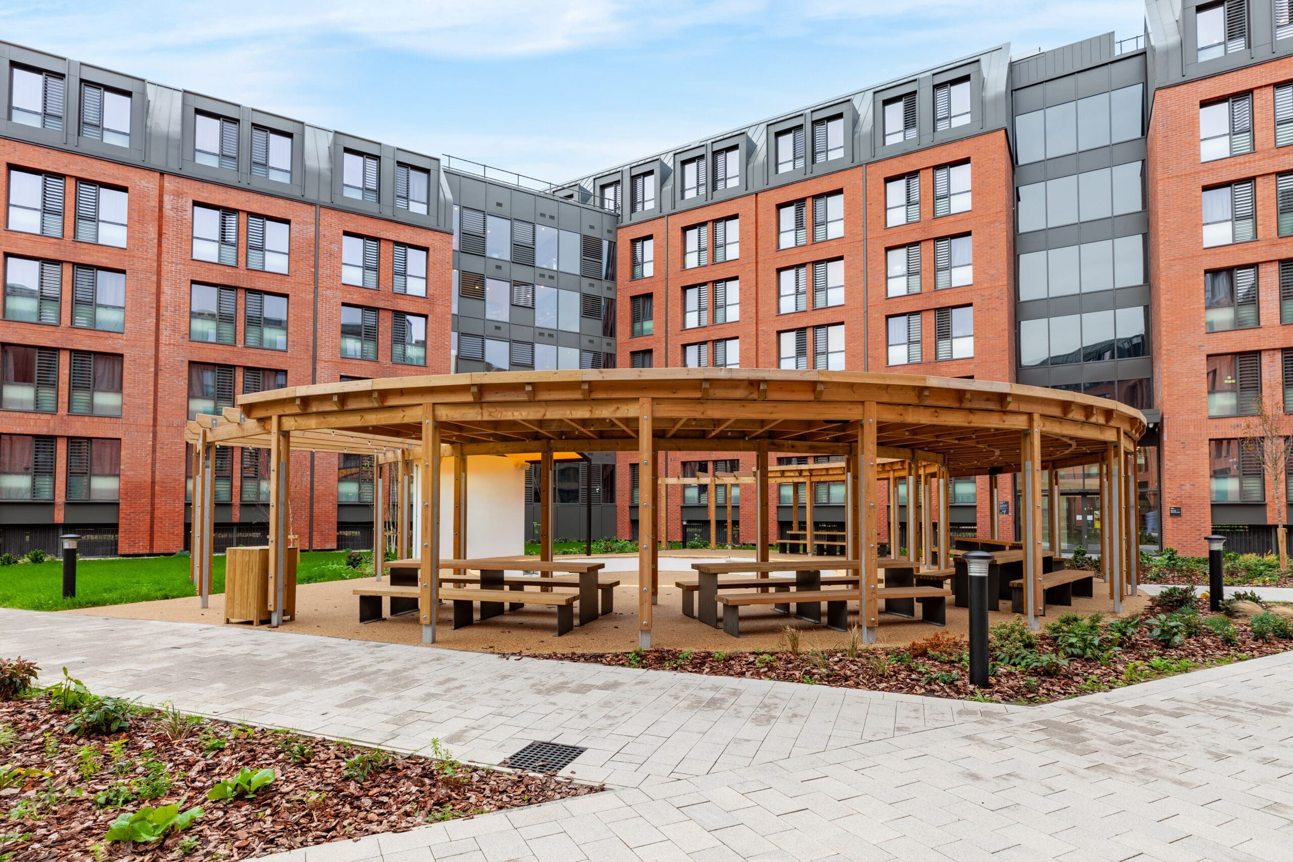 The curved outdoor shelter and picnic benches installed by Langley Design at Morriss House, Nottingham.