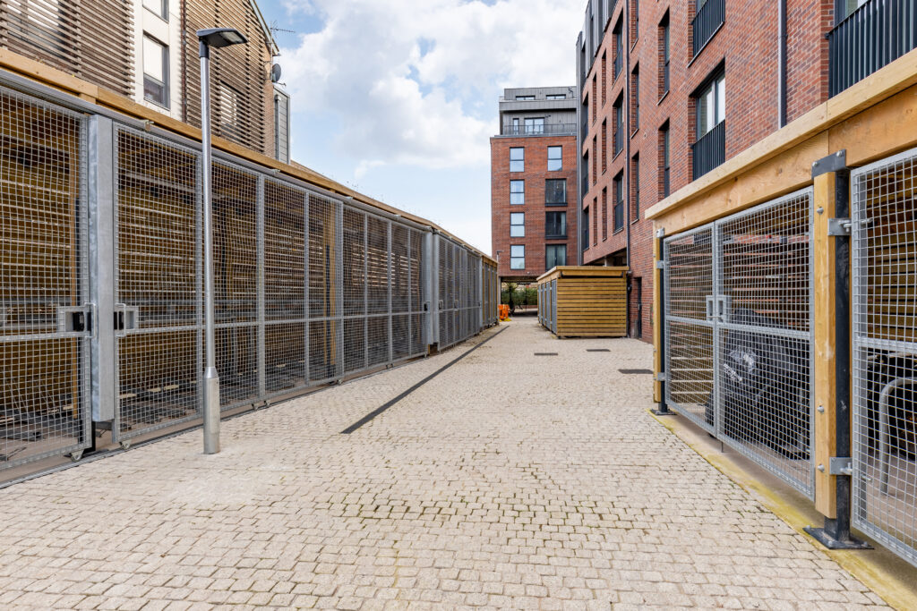 timber cycle shelters with steel mesh gates at McArthurs Yard