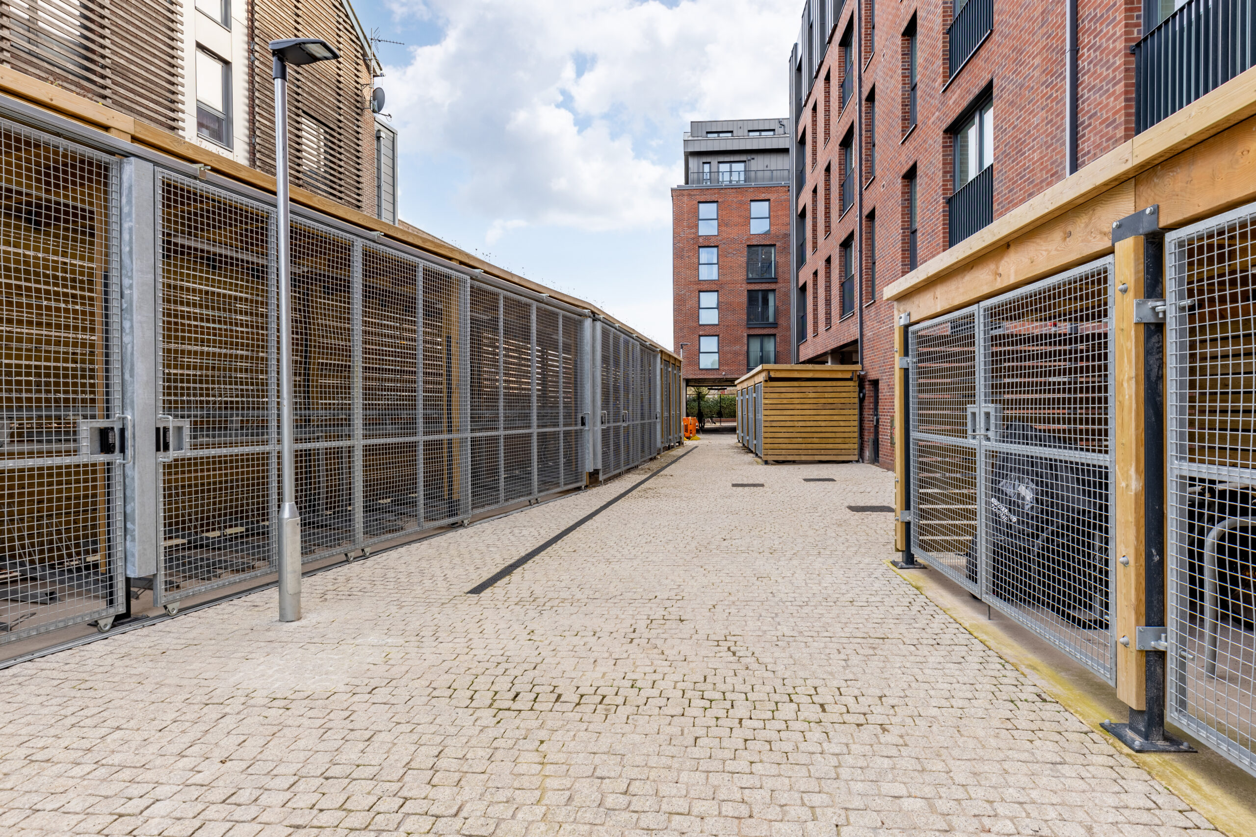 timber cycle shelters with steel mesh gates at McArthurs Yard