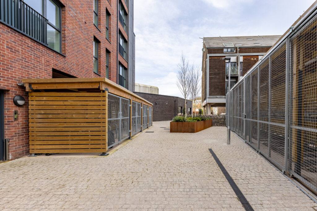 timber bicycle shelter with steel mesh gates and cycle racks