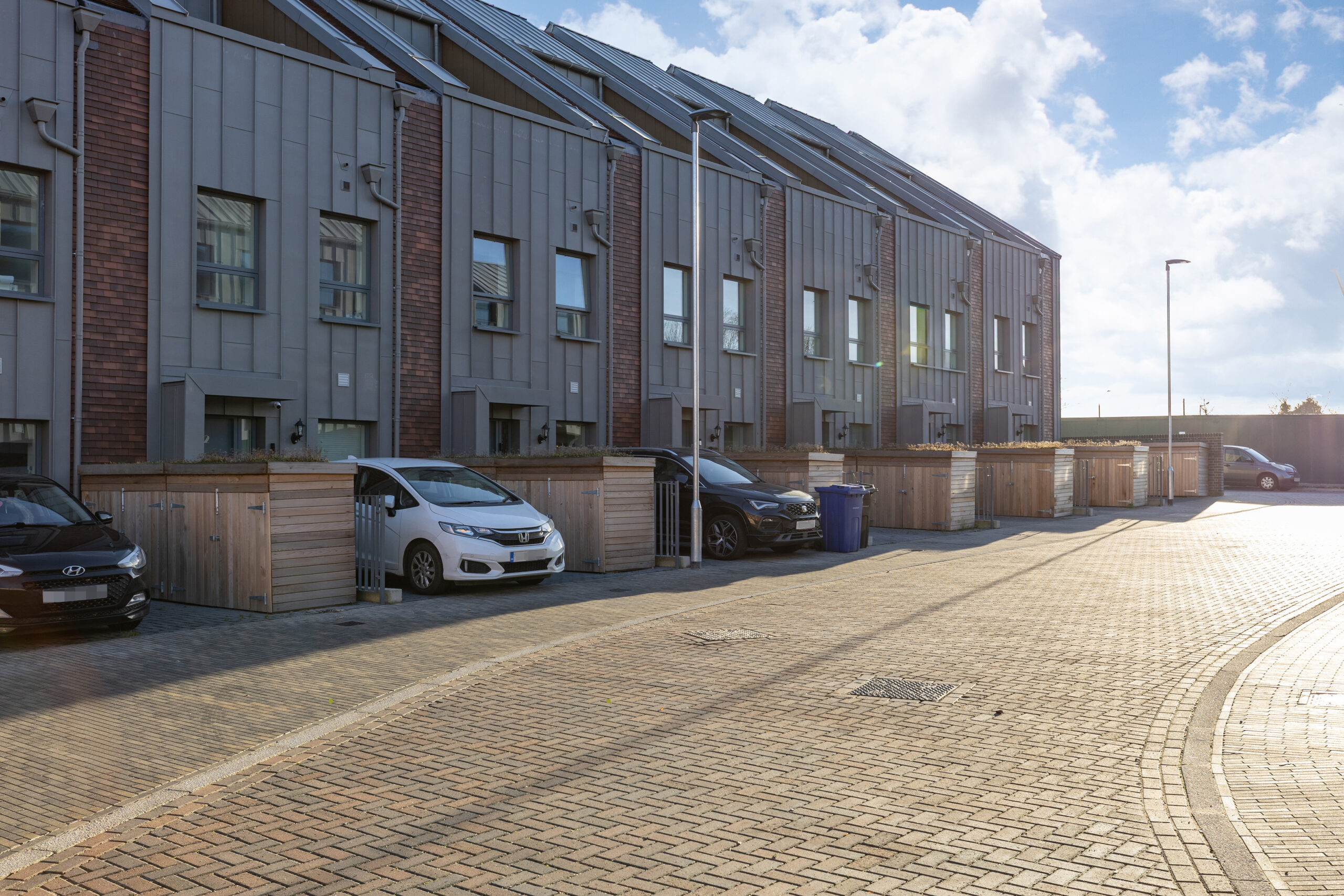 Purfleet Housing – cedar clad bin stores and cycle shelters help transform this residential development